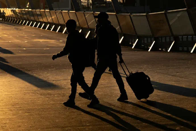 two person walking on road
