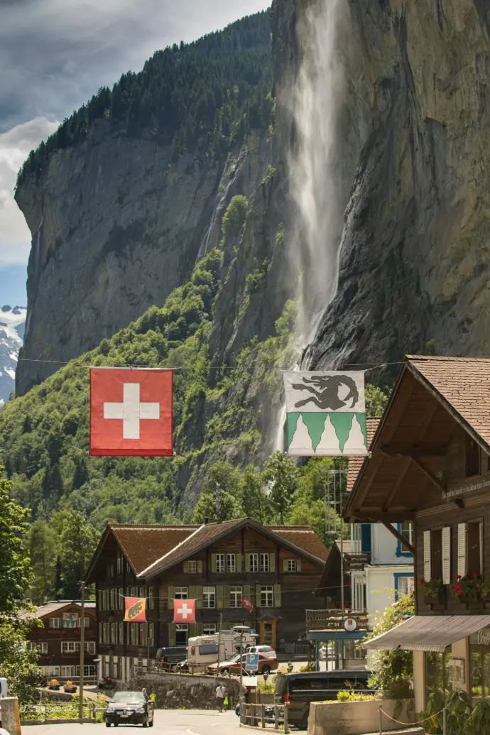 brown wooden house near waterfalls during daytime