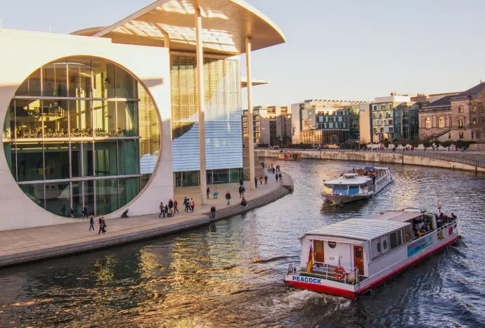 white and red boat near buildings